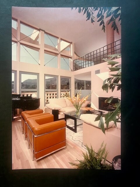 Interior of the Jacob Residence featuring floor-to-ceiling windows, modern furniture, and panoramic mountain views.