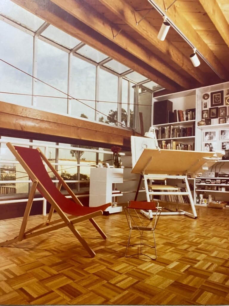 Loft studio space at the Pier Street Condos in Santa Monica featuring a skylit ceiling, exposed beams, and a drafting area.