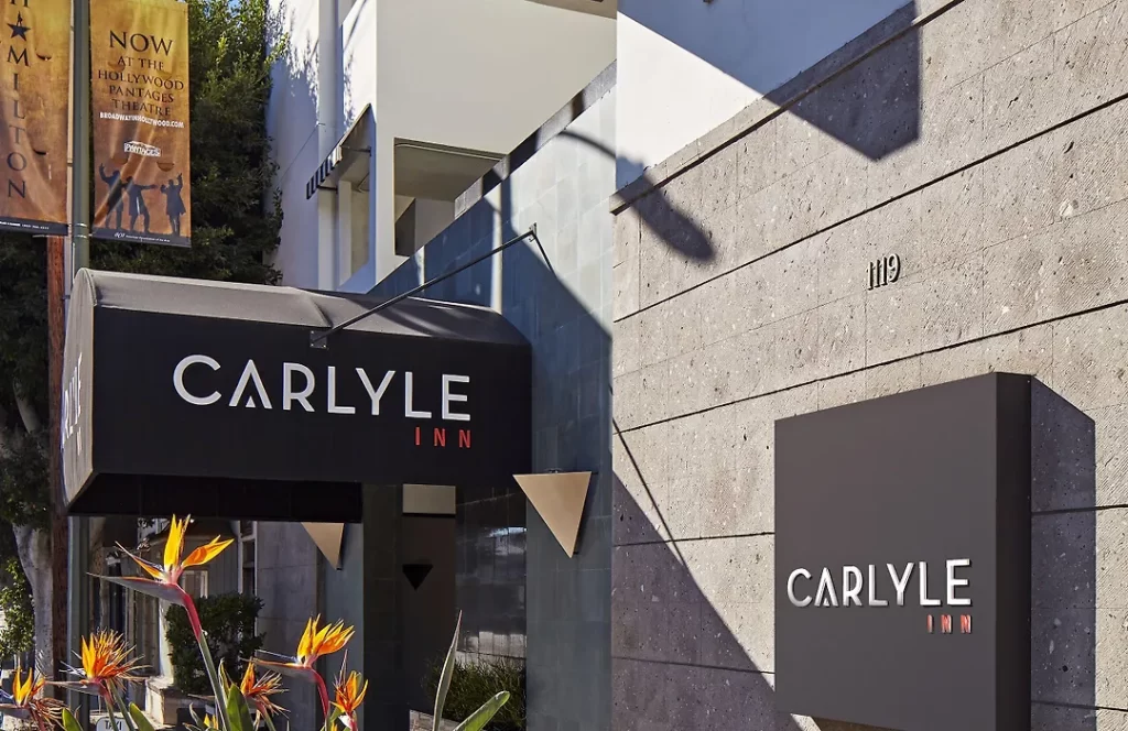 Main hotel entrance of The Carlyle Inn in West Los Angeles with branded signage and street frontage.